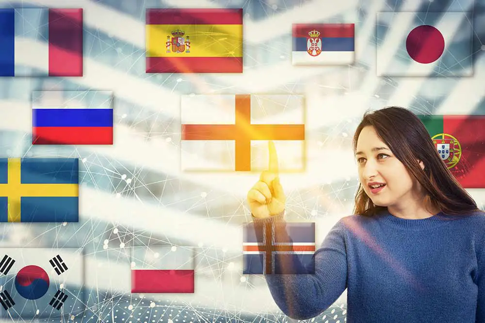 Frau berührt eine digitale bildschirmschnittstelle mit nationalflaggen, die verschiedene sprachen zeigen, die auf der ganzen welt gesprochen werden. lernen und sprechen mit moderner technik. internationales kommunikationskonzept.